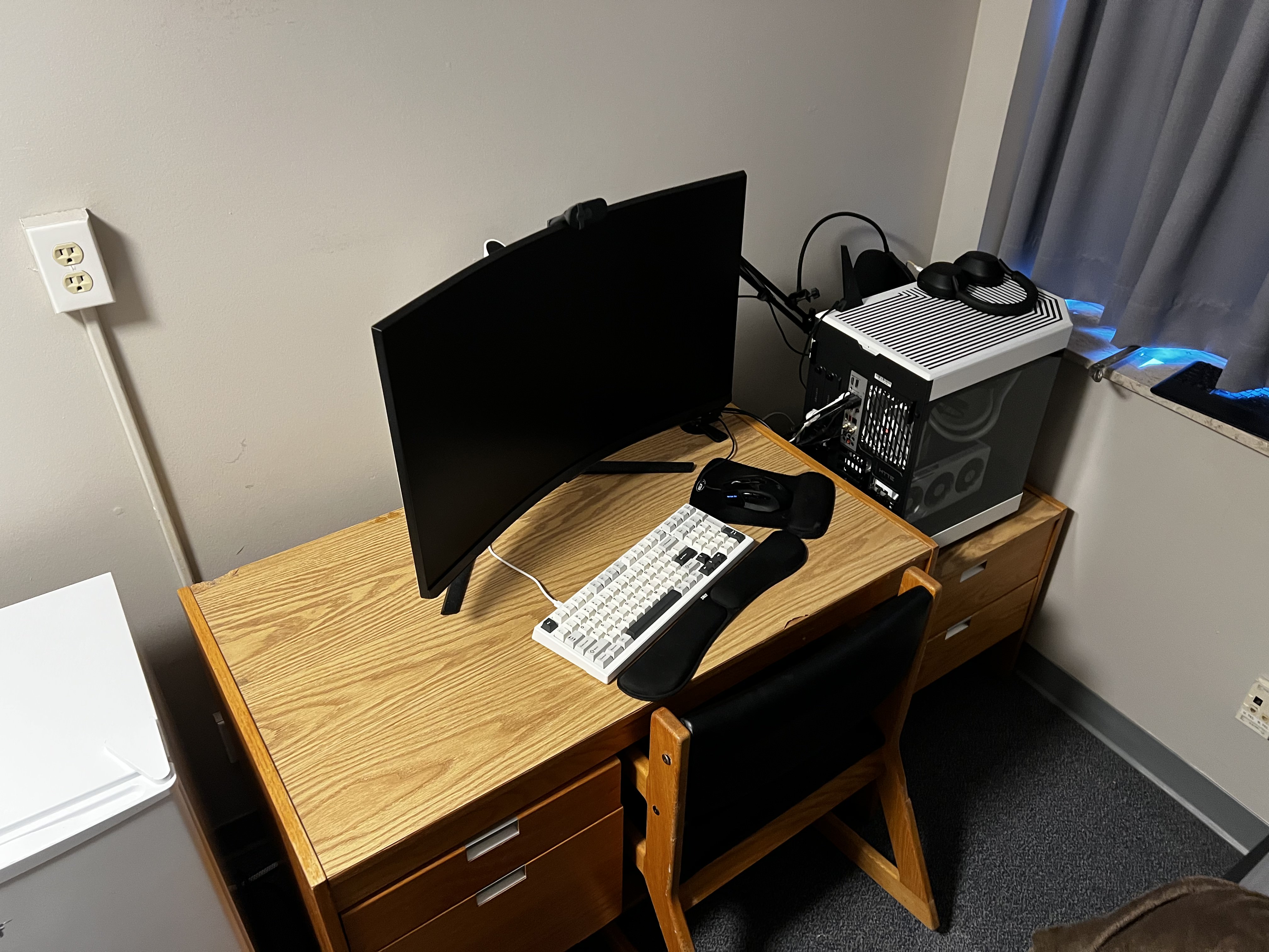 Clean desk setup with custom PC beside monitor