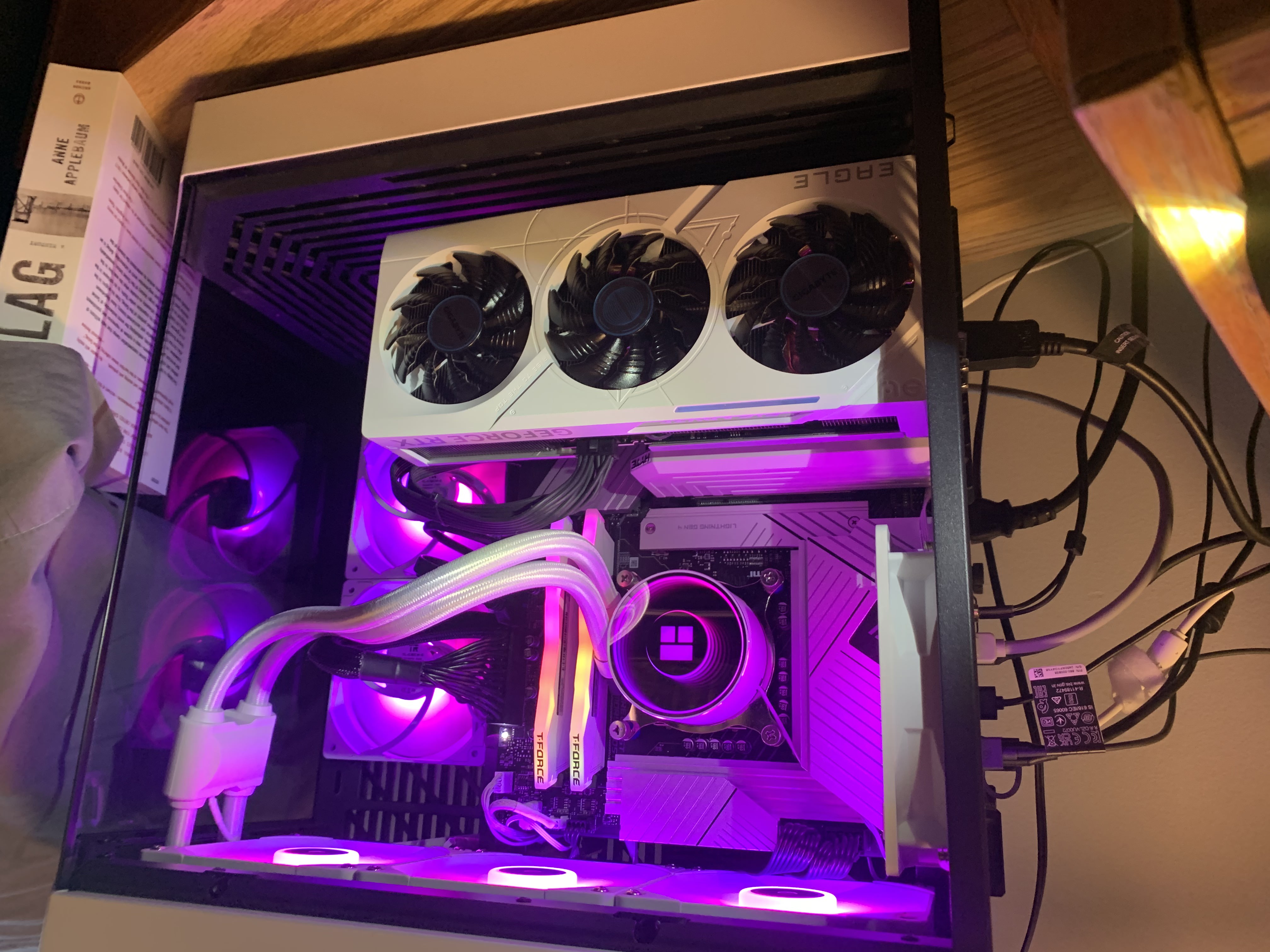 Inside of custom PC with white graphics card and RGB lighting