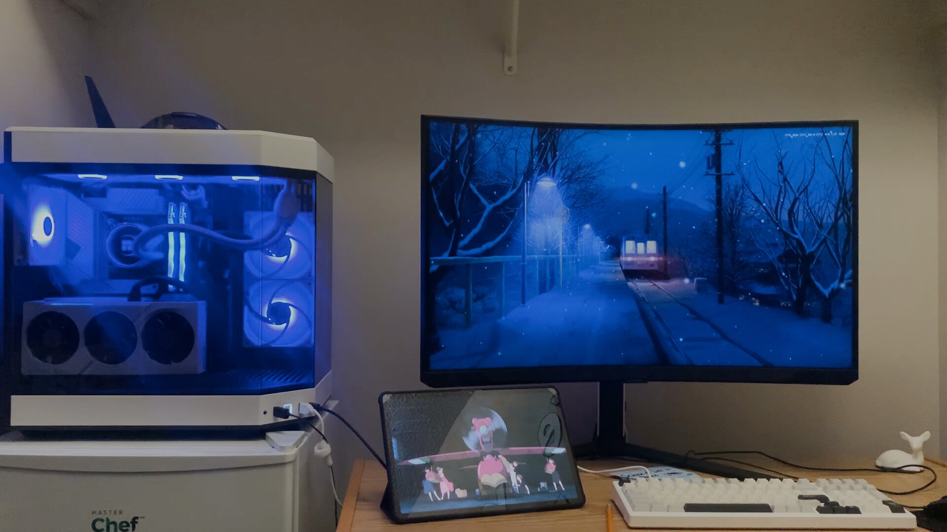 Custom PC and monitor setup with blue lighting at night