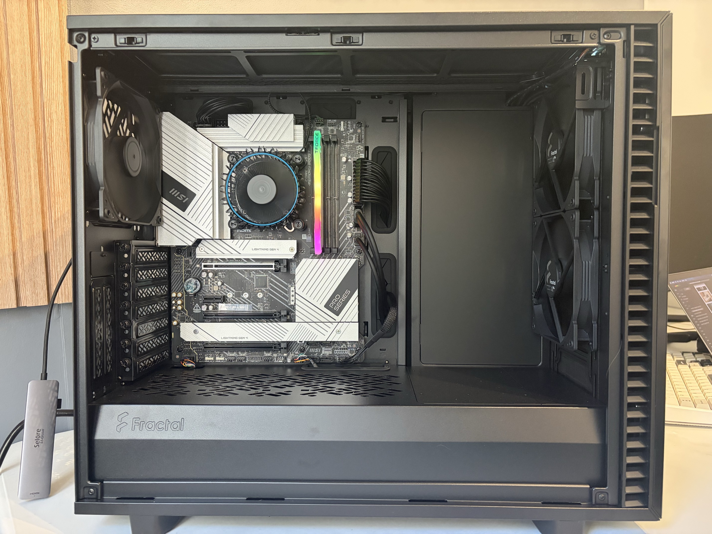 Inside the home server showing the motherboard, cooler, memory, and empty drive bays